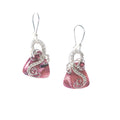 Dangle earrings with sterling silver loops and interlacing details curving down one side of a pink triangle-shaped stone, accented by a vintage red Austrian crystal, a glass bead, and scrollwork.