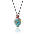 Drop-shaped pendant with original handcrafted stone painted in turquoise, yellow, and orange' sterling silver scrollwork, matte red jasper beads with silver and glass beads at the top, hung from a silk cord.