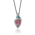 Drop-shaped pendant with an original hand crafted and hand-painted stone with pinks, and turquoises and sterling silver scrollwork, serpentine aquamarine beads with silver and glass beads at the top, hung from a silk cord.