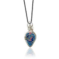 Drop-shaped original handcrafted stone pendant, hand painted with blues and accented with mauve; sterling silver scrollwork on the front, rose quartz beads with silver and glass beads at the top, hung from a silk cord.