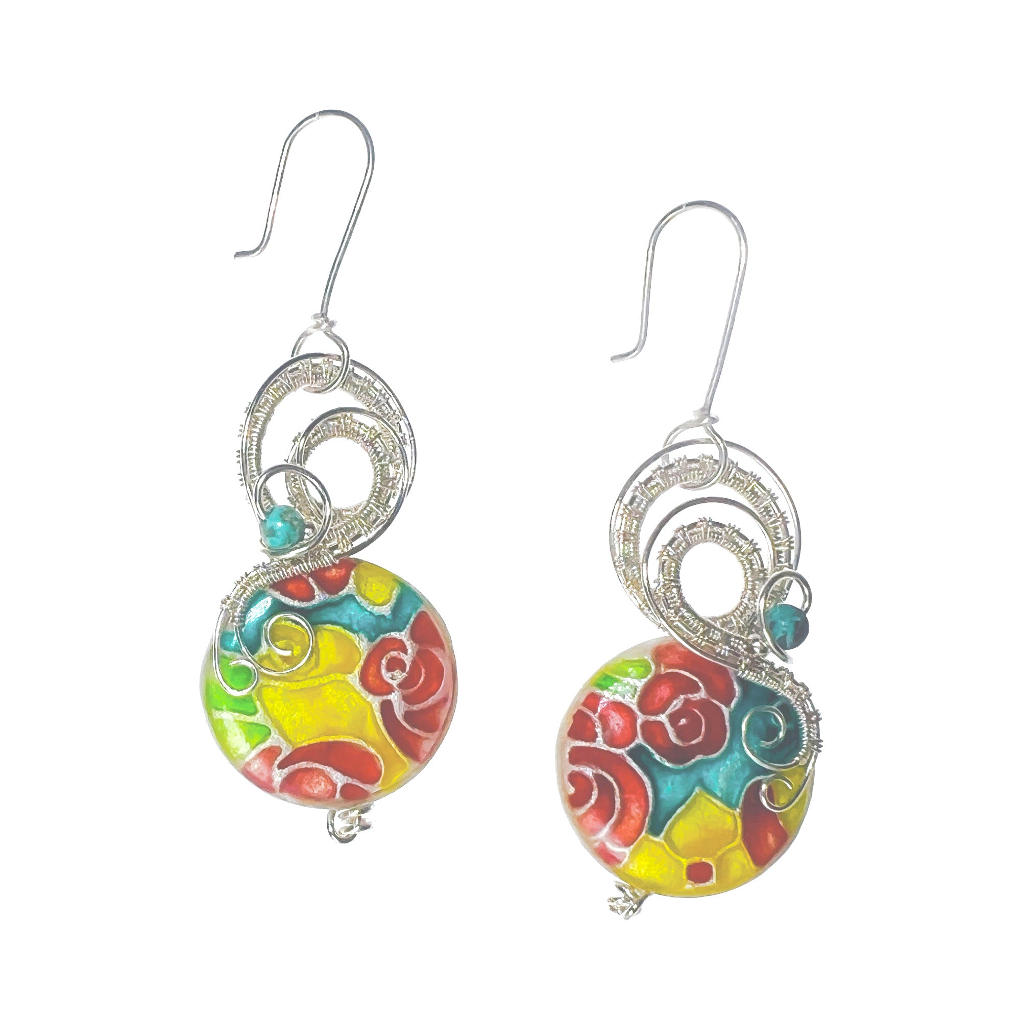 A pair of dangle earrings featuring turquoise bead accents and a red, turquoise,  and yellow floral pattern, suspended from sterling silver hooks.