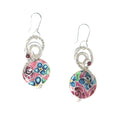 A pair of dangle earrings featuring magenta beads and a pink, teal blue, magenta and green floral pattern, suspended from sterling silver hooks.