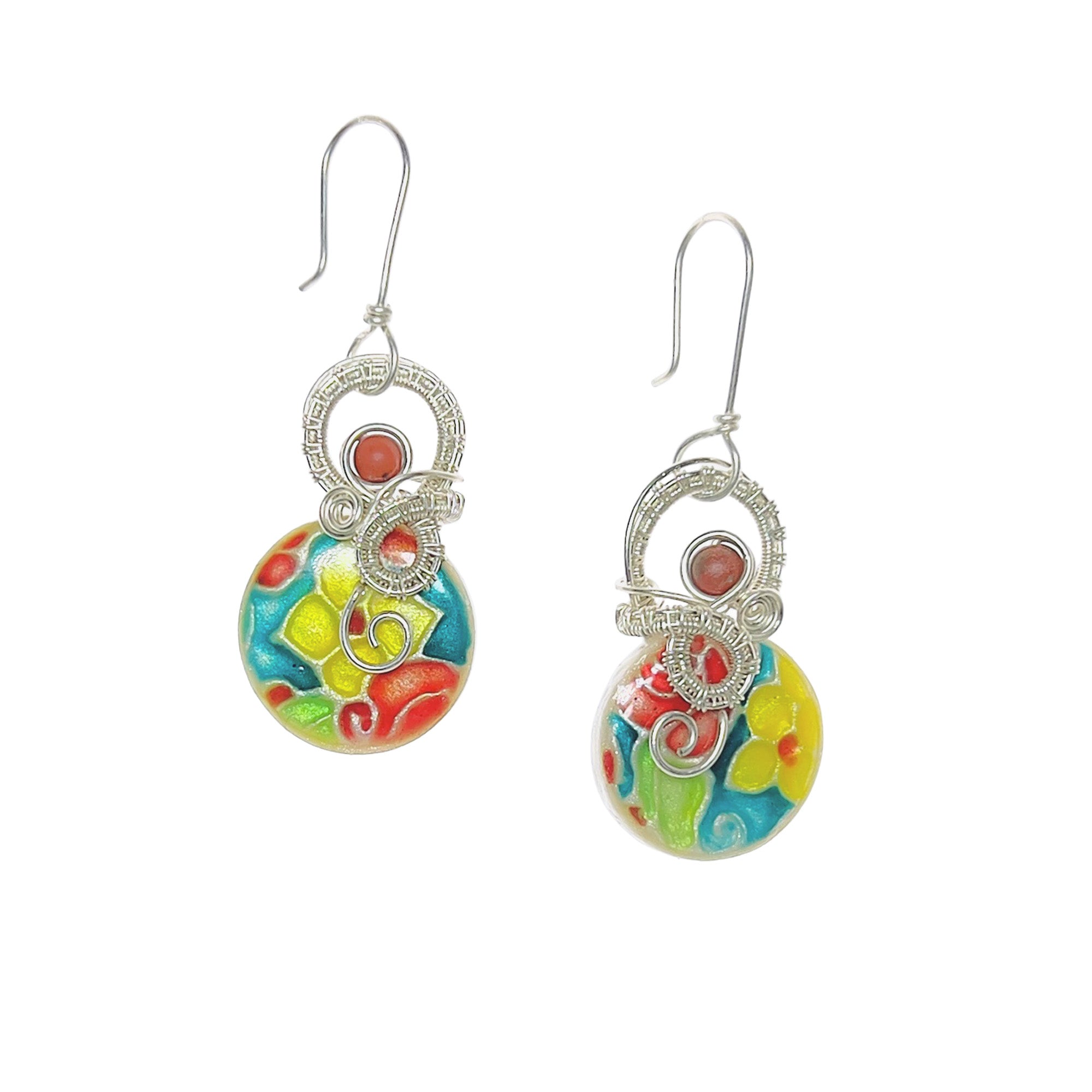Dangle earrings featuring sterling silver loops, a matte red jasper bead accent, and a floral pattern in turquoise, yellow, red and green.