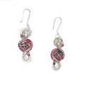 Round earrings featuring a pink stone with continuous interlaced sterling silver details framing its top and bottom, accented by two pink Austrian crystals.